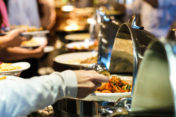 Hand of people take buffet food in hotel party