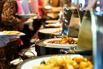 Hand of people take buffet food in hotel party
