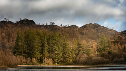 Stunning sunrise landscape image of Yew Tree Tarn in Lake District