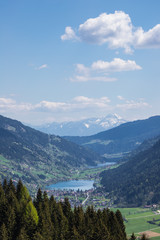 Fototapeta na wymiar Wonderful Spring Mountain Landscape Panorama View Through Valle Gegendtal With Lake Brennsee And Lake Afritz And Mt. Mittagskogel In Background