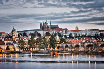 Fototapeta premium Evening in Prague. View of Prague Castle, Charles Bridge and the Vltava River Embankment. Czech Republic.