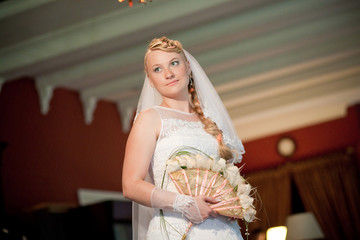 Fototapeta premium Beautiful happy young blondie bride in fashionable wedding dress. Celebration, wedding concept
