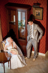 Obraz na płótnie Canvas Wedding romantic couple indoors in hotel. Elegant loving couple together 