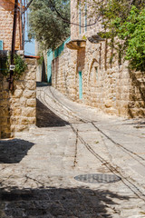 Fototapeta na wymiar This is a capture of the old roads in Der El Kamar a village Located in Lebanon and you can see in the picture the old walk made of stones with an historic architecture for walls and houses 