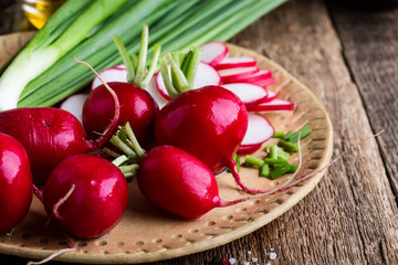 Fresh springtime radishes, green onion and garlic,  plant based food