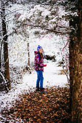 Obraz premium Girl Walking in a Snow Covered Woods