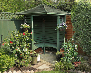 An English back Garden with Bench and Flower basket