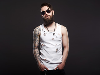 Obraz premium Brutal bearded hipster boy in glasses and vintage shirt