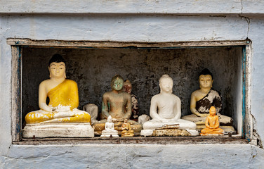 figurines of Buddha in a niche