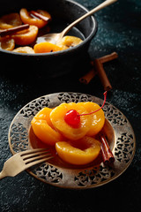 Preserved peaches with cinnamon and  cherry.