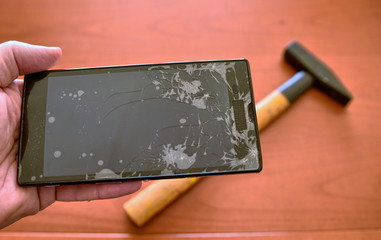 Close-up with selective focus on the shattered screen of a smartphone