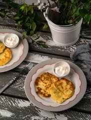 pancakes and sour cream, on a wooden rustic backdrop