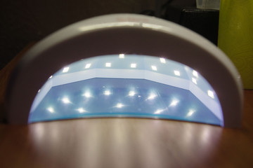 White UV lamp for manicure on the table