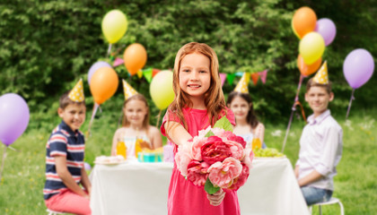 childhood and people concept - happy red haired girl with flowers over background