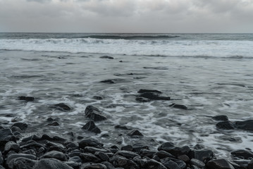 Waves on beach at sunset