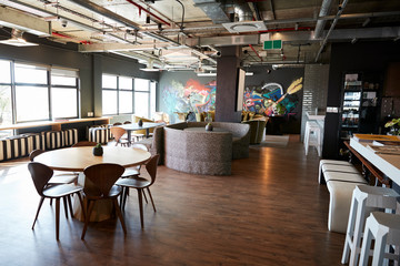 Eating and casual meeting area in the office of a creative business, daytime, no people