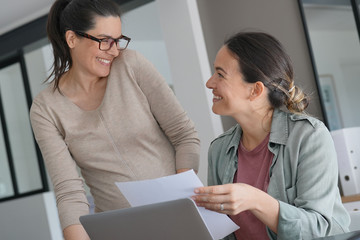 Women working in office on laptop computer