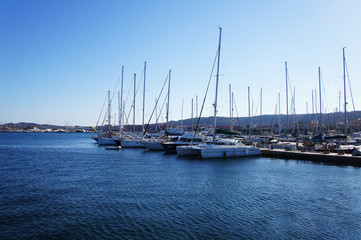 Fototapeta premium Yacht club with snow-white ships on the pier in the lagoon in the port.