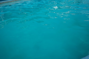 Fototapeta na wymiar Inviting blue pool with ripples on the surface