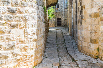 This is a capture of the old roads in Der El Kamar a village Located in Lebanon and you can see in the picture the old walk made of stones with an historic architecture for walls and houses 