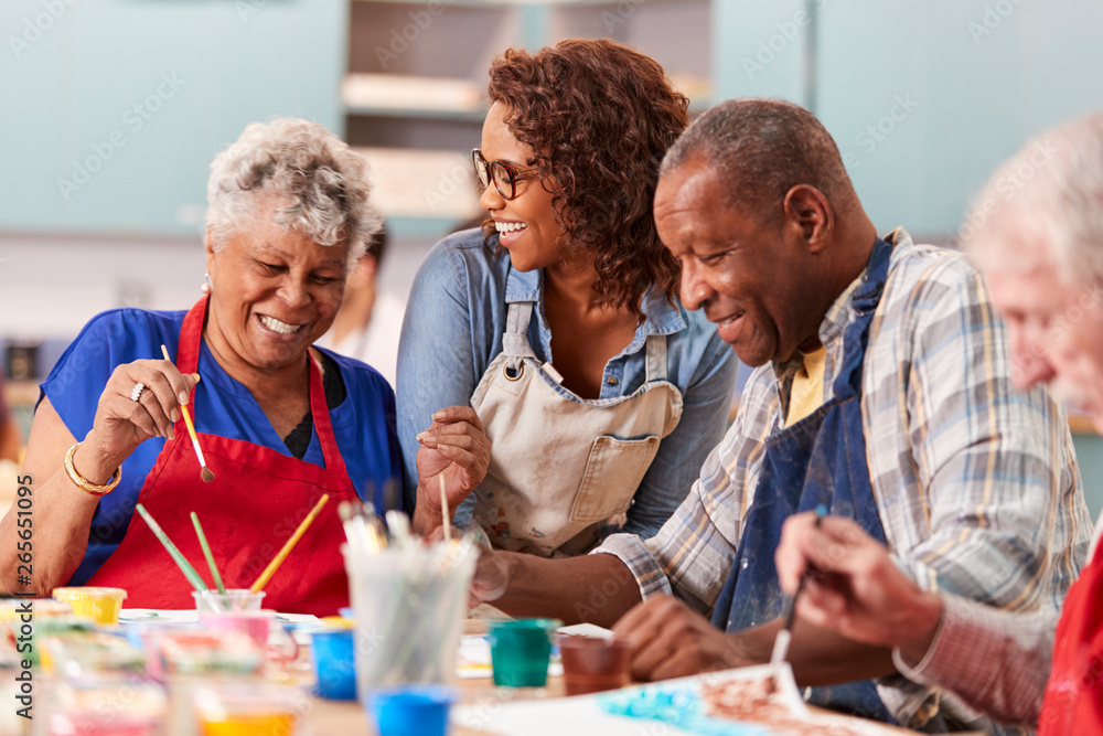 Wall mural Group Of Retired Seniors Attending Art Class In Community Centre With Teacher