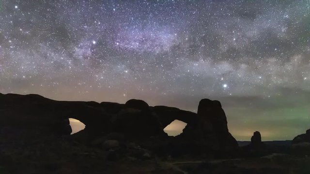 Time lapse of the milky way rising behind the 'Windows' arches in Arches National Park - Moab, Utah. 