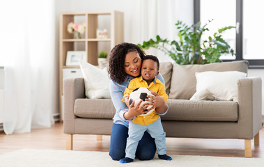 childhood, kids and people concept - happy african american mother and her baby son playing with...
