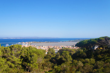 Top view of the old European city with red roofs near the sea in the summer on the southern island.