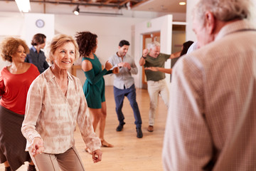People Attending Dance Class In Community Center