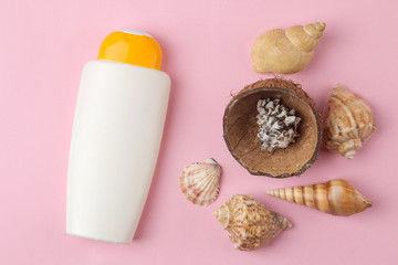 Sunscreen. various sunscreens and seashells on a bright pink background. summer. vacation. Sun protection. top view