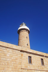 Fototapeta na wymiar Lighthouse closeup against the blue sky.