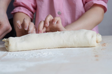 Obraz na płótnie Canvas Children mold cheesecakes from dough. Kitchen table in flour. Warm relationships children