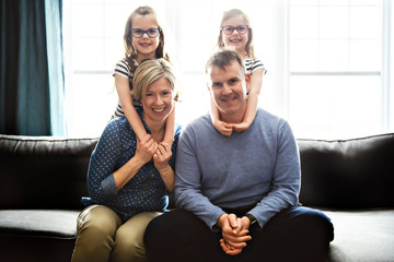 A Portrait of nice cute cheerful family parent with the twin girls