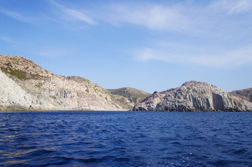 Fototapeta na wymiar View of the white and yellow mountains of the cliffs growing from the sea on the shore from a boat. Blue Lagoon.