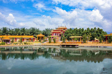 View of a beautiful chinese temple and a clear pond in Seen Hock Yeen Confucius Temple in Chemor, Perak, Malaysia from flowery walkways.