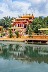 View of a beautiful chinese temple and a clear pond in Seen Hock Yeen Confucius Temple in Chemor, Perak, Malaysia from flowery walkways.