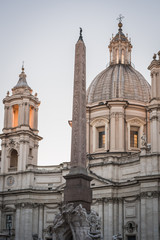Fototapeta na wymiar The column and the building of Piazza Navona in Rome