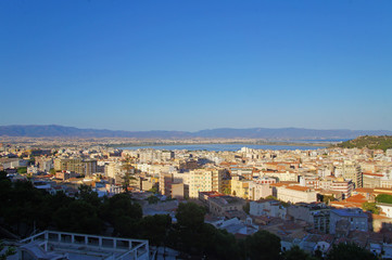 Cityscape view from above on the old medieval European Italian city with red roofs in the summer in the sun.