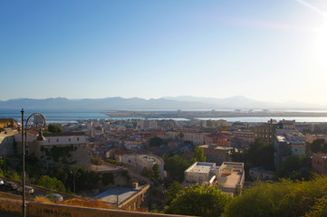 Fototapeta premium Cityscape view from above on the old medieval European Italian city with red roofs in the summer in the sun.