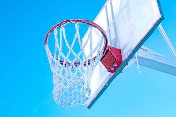 winter Playground in severe frost, basketball Hoop and shield covered with frost