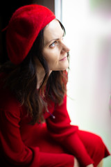 nice Woman in red with beret looking outside