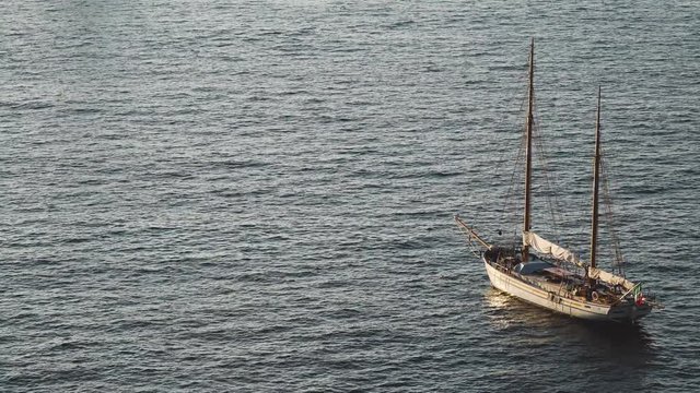 Yacht in the Mediterranean Sea at sunset, luxury travel tour, space for text, summer, ocean surface, water transport, fishing, vacation, two-masted yacht,