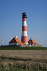 Fototapeta na wymiar Der Leuchtturm Westerheversand auf der Halbinsel Eiderstedt in Nordfriesland