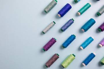 colorful sewing threads with empty space for text, top view