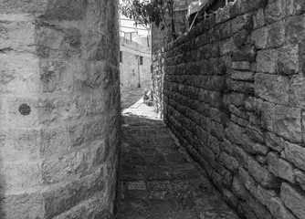 This is a capture of the old roads in Der El Kamar a village Located in Lebanon and you can see in the picture the old walk made of stones with an historic architecture for walls and houses 