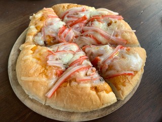 Close up of Seafood pizza on a wooden tray