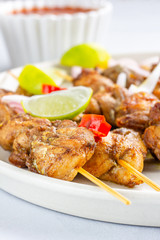 Close Up View of Chicken Satay with Peanut Sauce and Salad Popular Indonesian and Thai Appetizer. Thai Food, Oriental Cuisine, Barbecue Chicken.