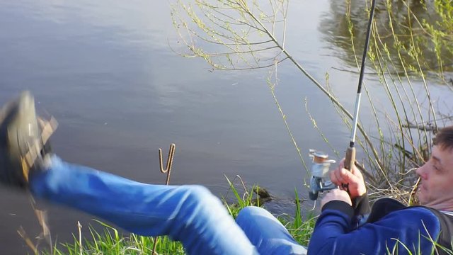 Fisherman pulls fish from shore.1920X1080 Full Hd.