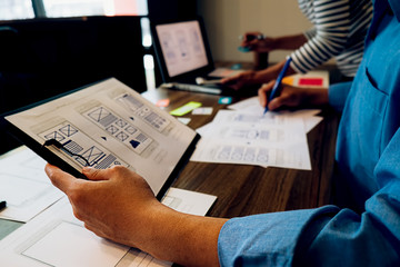 Creative Web Designer planning application and developing template layout, framework for mobile phone. User experience (UX) concept.