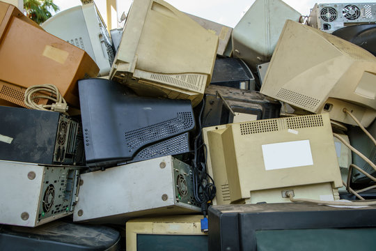 electronic waste stack together Monitor, Printer, desktop computer, fax for waiting to be recycled. Produced from plastic, copper, glass can be reused.